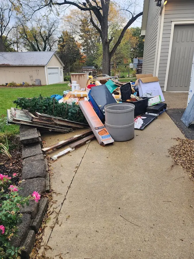 Dumpster being loaded with debris for 12 Yard Dumpster Rental in Lytle